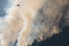 A helicopter fights a forest fire in BC